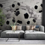 Fotomurales Balones de fútbol que atraviesan la pared.